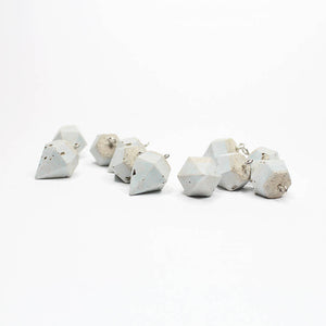 A pair of concrete earrings in the geometric form of diamonds. Duck egg/grey or gray. Silver sterling hooks.